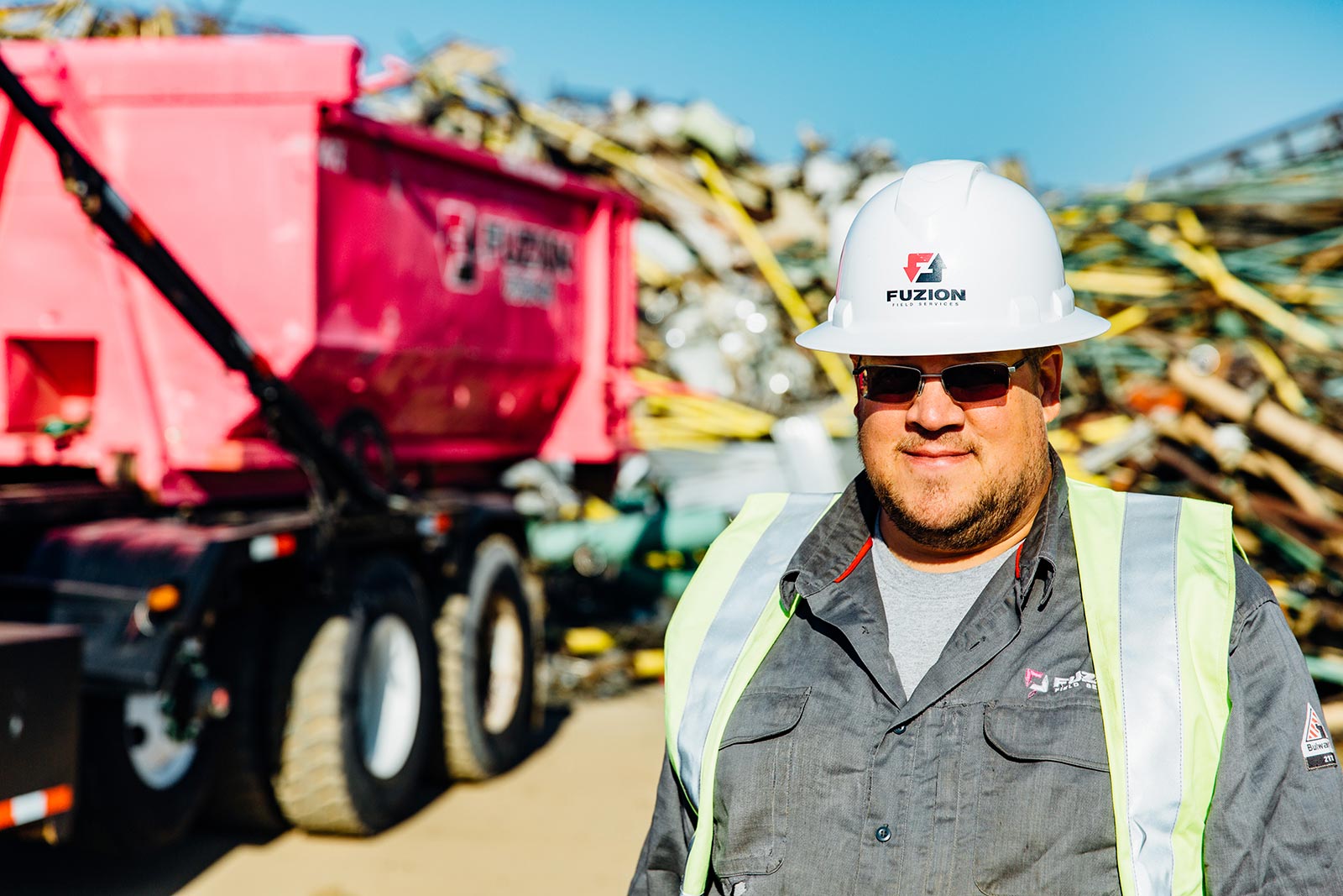 Fuzion Field Services worker with scrap metal pickup.