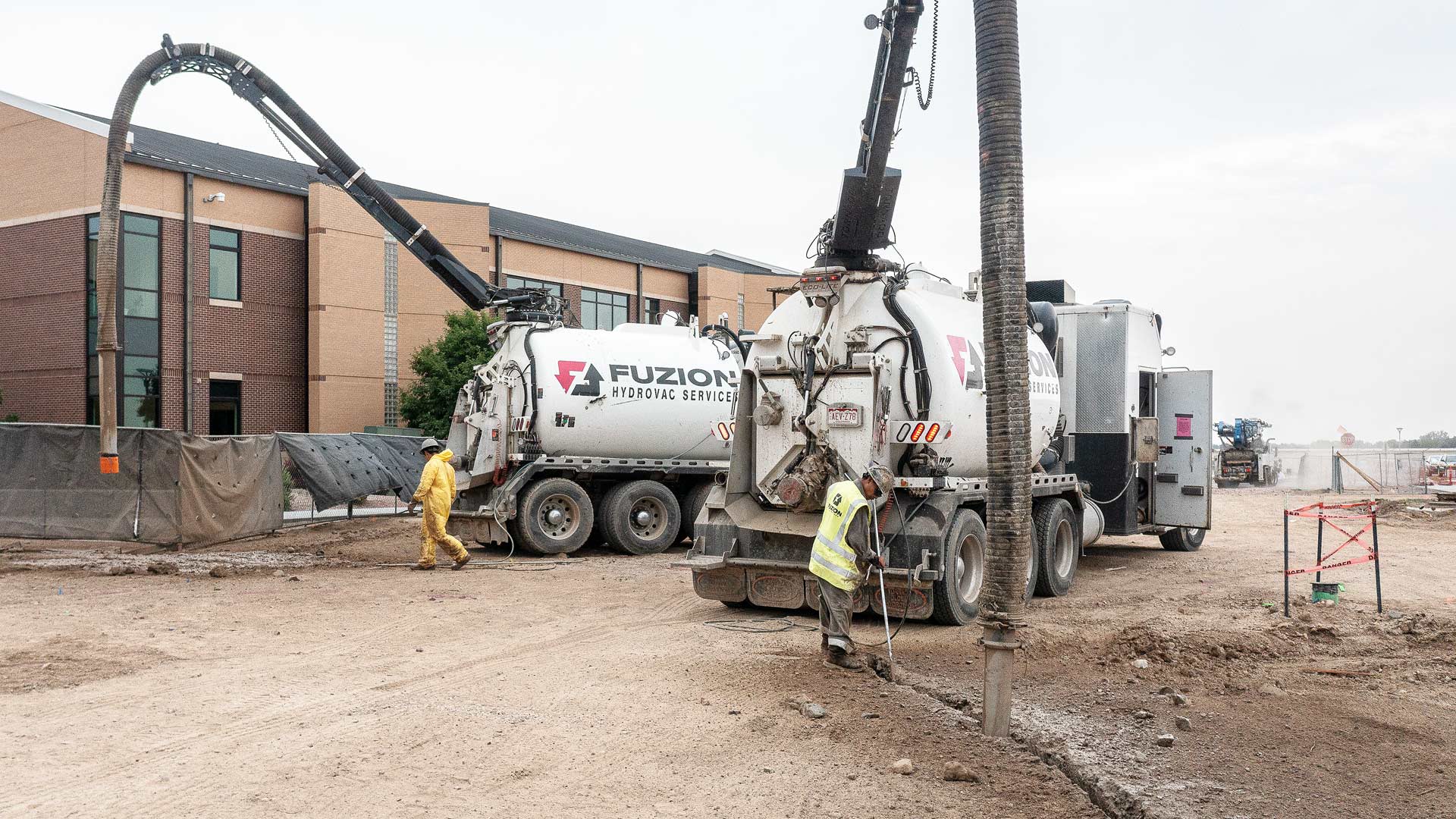 A Fuzion Field Services hydrovac truck excavating for utility daylighting.