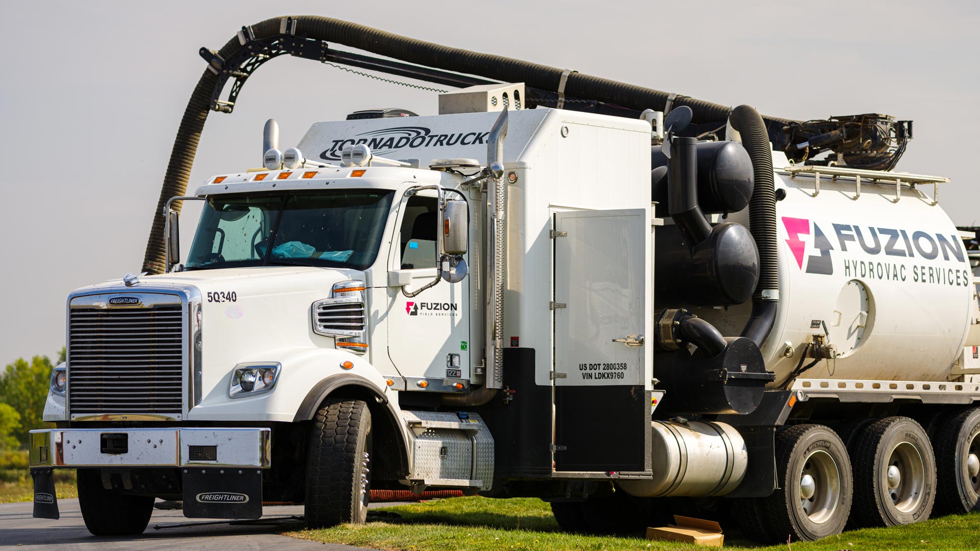 A Fuzion hydrovac truck set up at a job site.