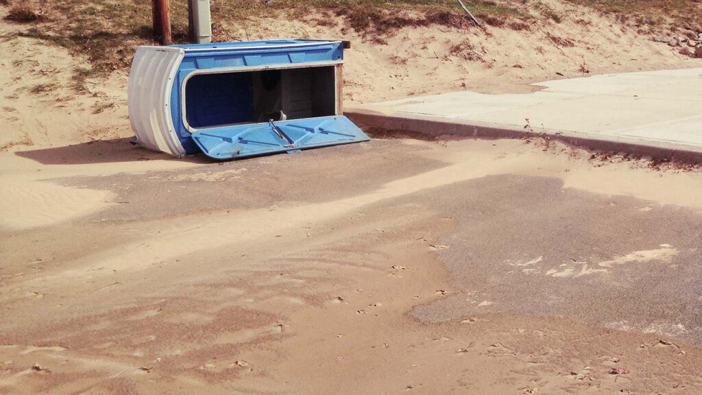 A portable toilet that has been tipped over.