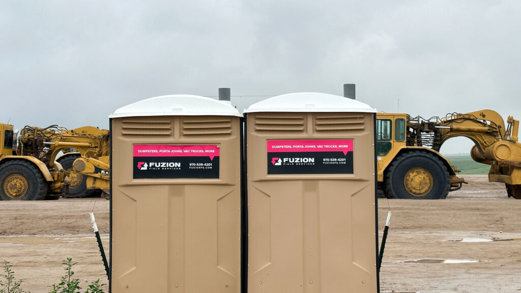 Fuzion porta potties on a construction site.