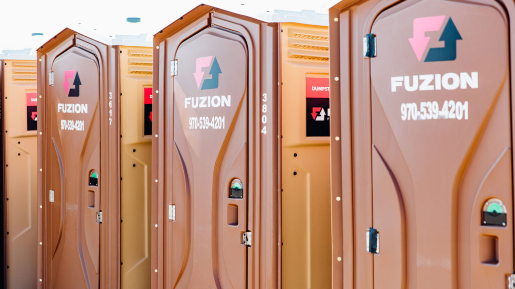 Row of Fuzion porta potties.