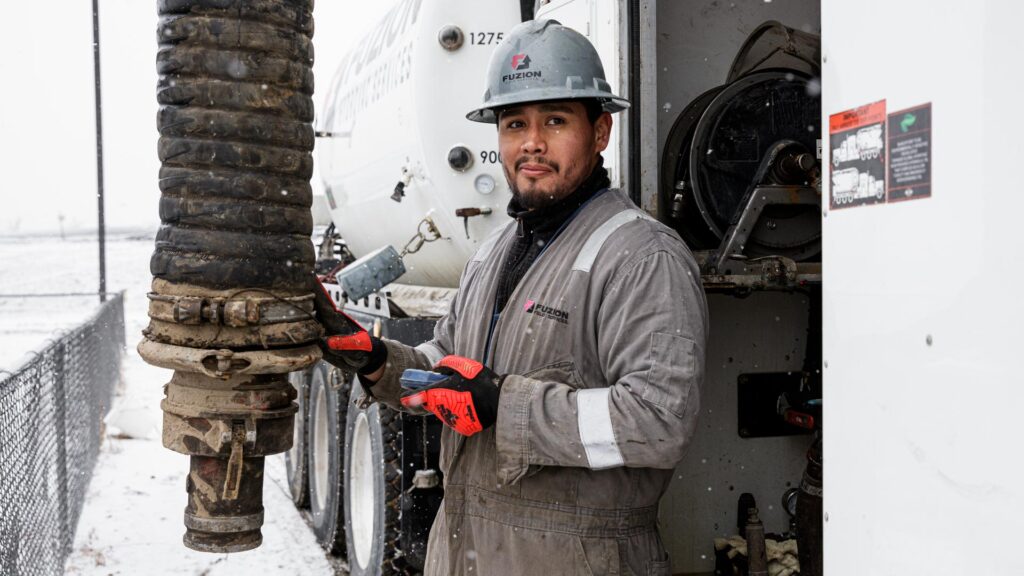 Hydrovac operator working on a cold and snowy day.