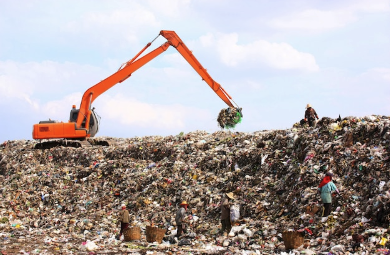 An excavator working in a landfill.