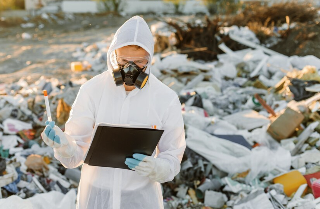 A professional conducting research at a landfill.