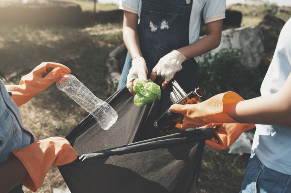 Image of people gathering items to be recycled.