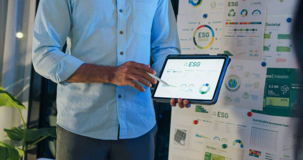 A man presents an ESG report on his iPad.