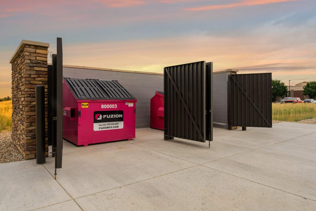 A Fuzion dumpster in a community area.