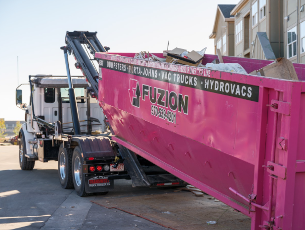 Fuzion truck lifting a Fuzion dumpster for removal.