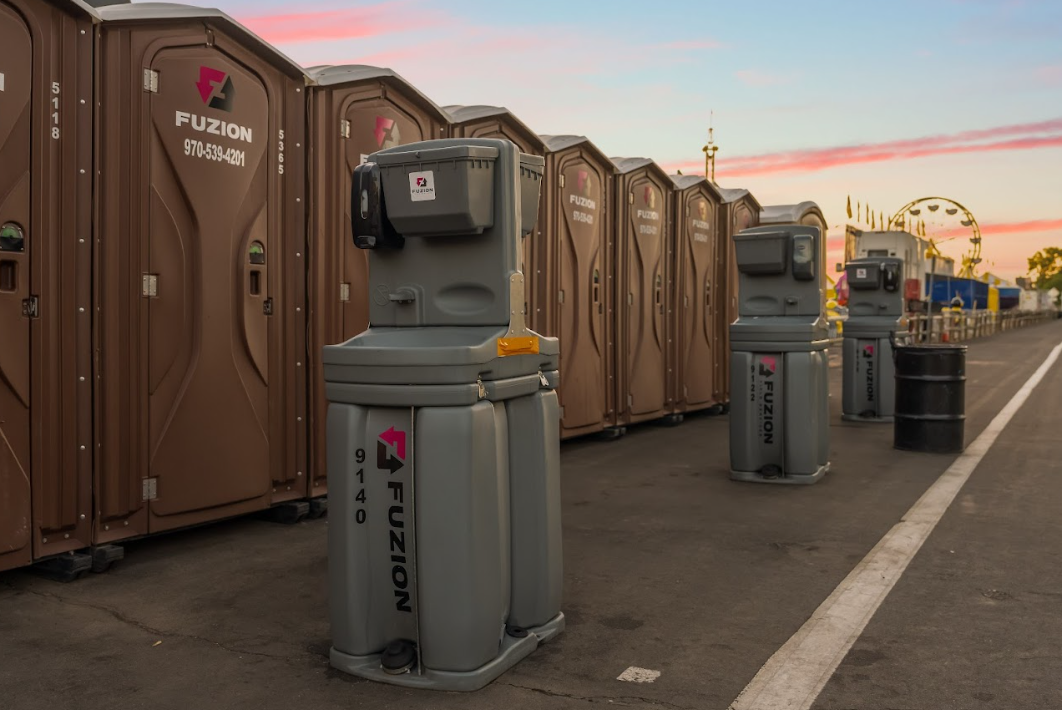 Close-up of blue portable handwashing stations with soap dispensers.