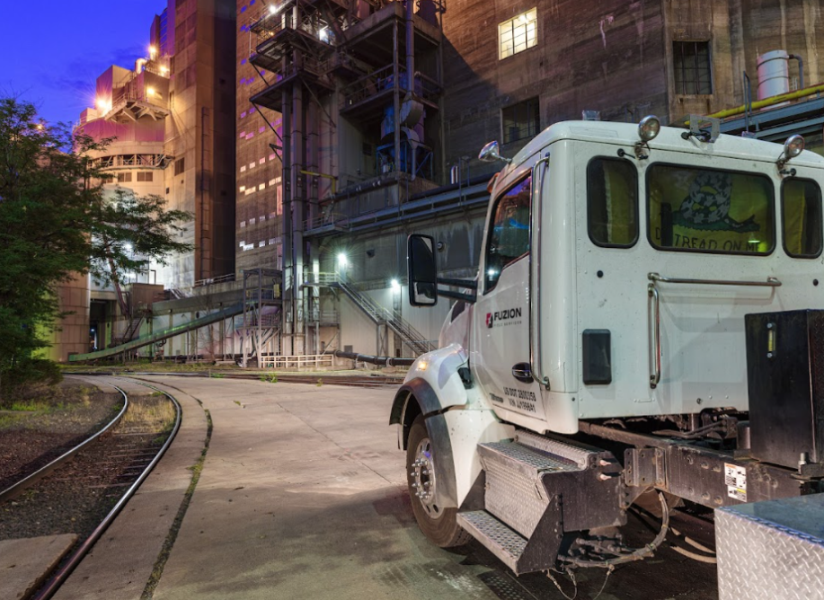 Fuzion truck parked at an industrial facility prepared for commercial-scale composting operations.