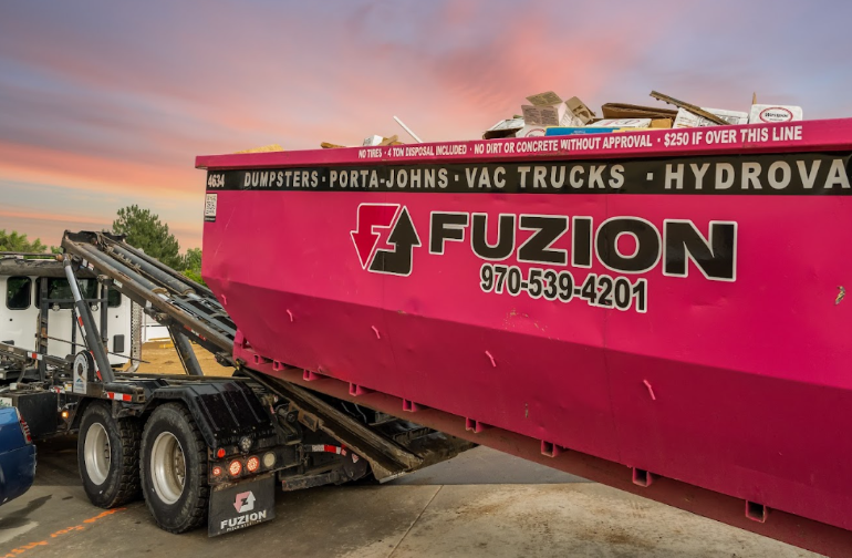 Fuzion dumpster being hauled away as part of modern waste and recycling trends.