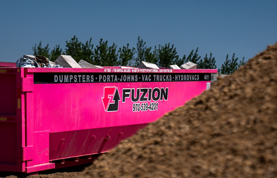 Fuzion dumpster on a job site helping contractors stay within their dumpster budget.