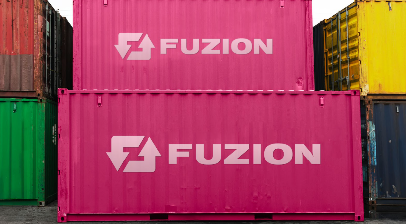 Stacked pink shipping containers with branding, used for storage container rental.