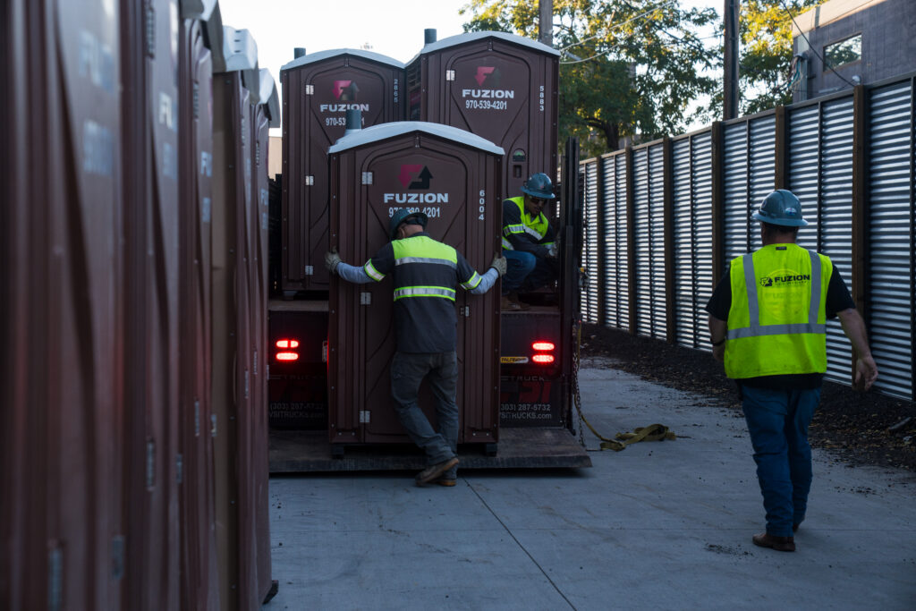 Fuzion experts dropping portable toilets off at multiple locations.